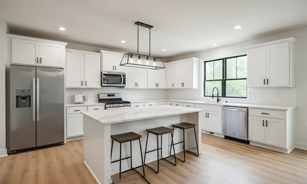 Modern kitchen with island, stainless steel appliances, and white cabinetry at Atlantic Community Memphis duplex rentals.