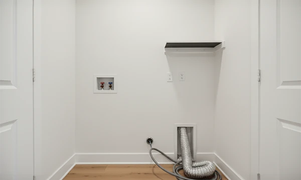 Laundry room with washer and dryer hookups in a new duplex home at Atlantic Community Memphis.
